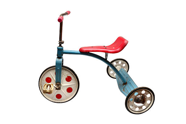 Old Children tricycle in a metal scrap heap