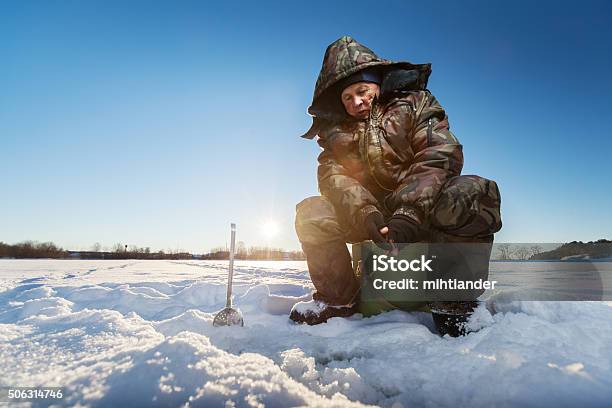 Fisherman On A Winter Lake Stock Photo - Download Image Now - Ice Fishing, Hole, Active Lifestyle