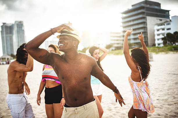 istock friends dancing on the beach for a party 506315002
