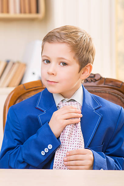 istock Little boy adjusting big tie 506315192