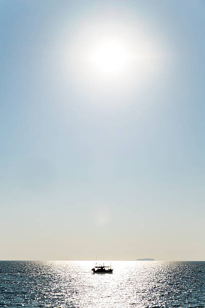 istock Ship in a wild ocean with the sun 506316030