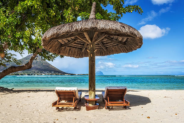 Loungers and umbrella on tropical beach in Mauritius stock photo