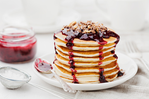 Fritters or american pancakes with blackcurrant jam and grated chocolate