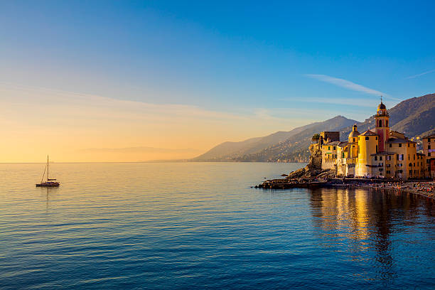 Mediterranean Sea at sunrise, small town and yacht stock photo