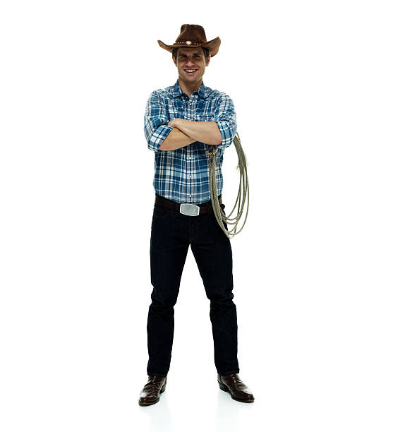 istock Smiling cowboy standing with arms crossed 506317398