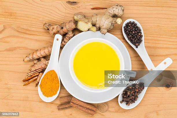 Healthy Turmeric Milk Tea With Ginger Cinnamon Cloves Black P Stock Photo - Download Image Now