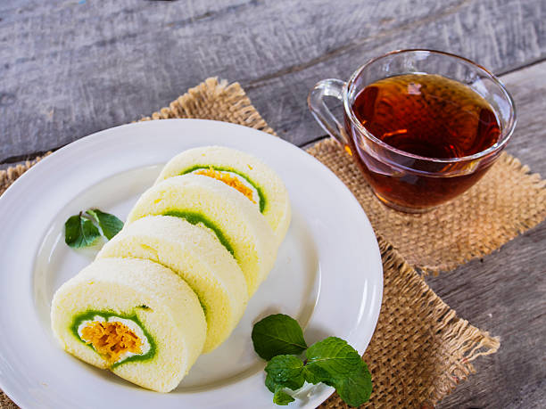 istock Roll cake and tea on wooden 506318886