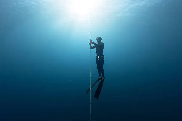 Free diver performing warm up dive - static apnea on the depth
