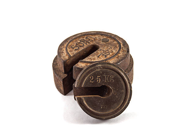 Old rusty iron scale weight isolated on white background. perfect for economics, finance and business articles