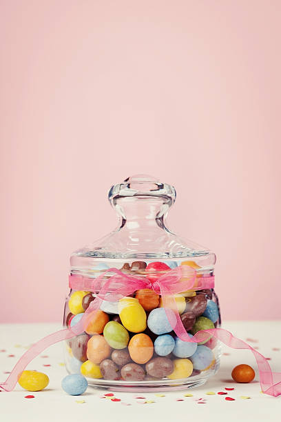 istock Chocolate candy or sweets with bow ribbon against pink background 506320930