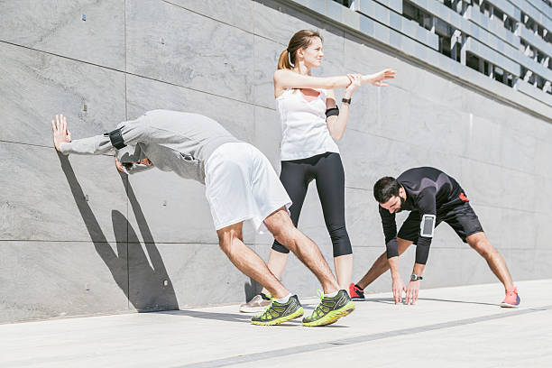 istock Three young friends doing stretching outdoors 506324828