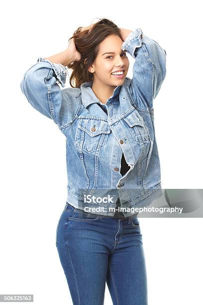 Cute Girl Smiling With Hands In Hair Wearing Jeans Stock Photo - Download Image Now - 20-29 Years, Adult, Adults Only