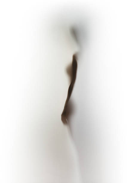 istock Female silhouette of sexy lady stands behind a diffuse surface 506325355
