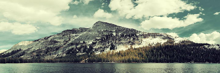Snow mountain cloud and lake panorama with reflections in Yosemite.