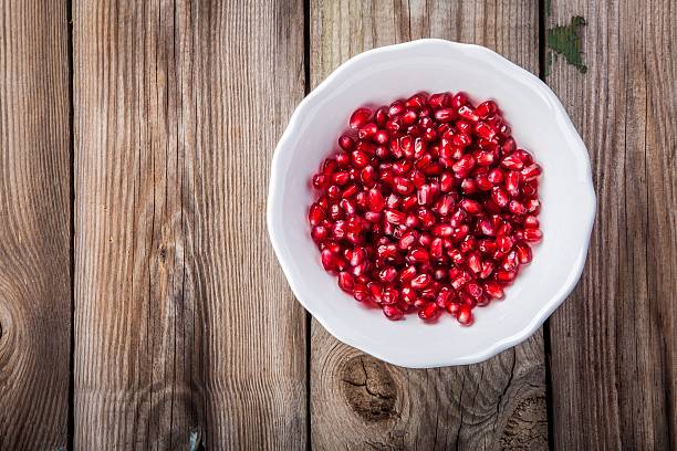 istock Fresh juicy pomegranate seeds on a plate 506328736