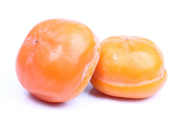 istock Two Fuyu persimmons 506329672