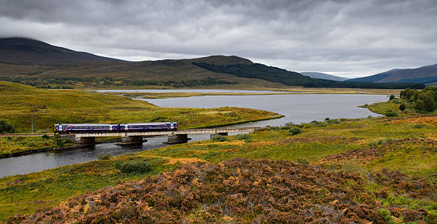 Inverness, Scotland - 25 September 2013: A Scotrail Class 158 train crosses Plantation Viaduct on the Kyle of Lochalsh Line. Knorr-Bremse RailServices are currently refurbishing and modernising Scotrail's fleet of the 25 year old trains at Springburn.