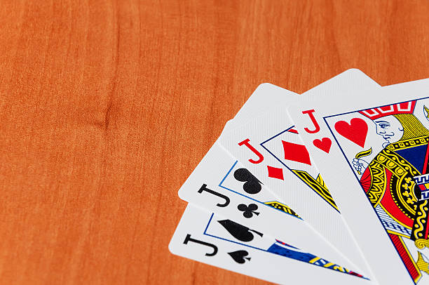 istock Old playing cards on wooden background 506330714