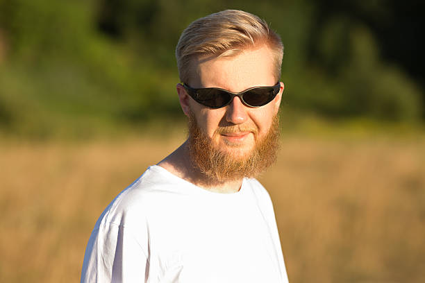 istock Young smiling bearded man in sunglasses 506330775
