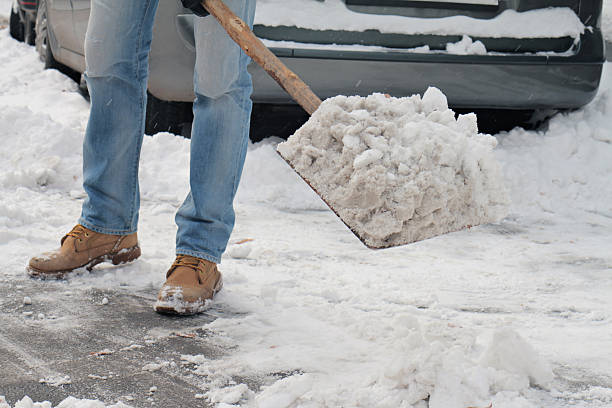 istock Man cleaning snow from  sidewalk in front of  house. 506330976