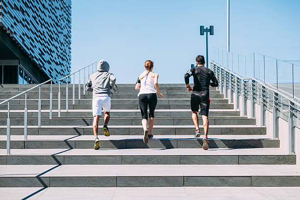 istock Three young friends running on the steps of a building 506331382