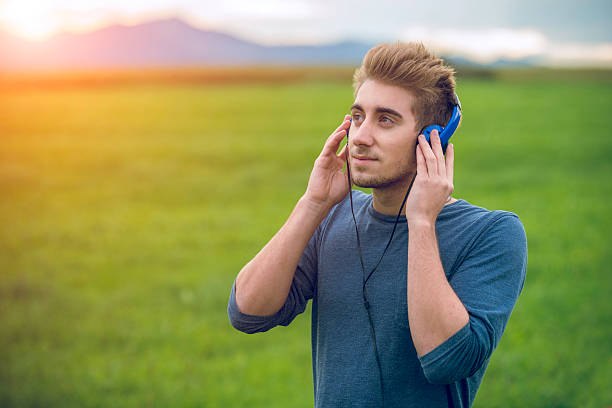 istock Young man with headphones outside 506340776