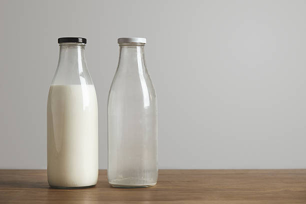 istock Simple vintage bottles with fresh milk and empty 506340870