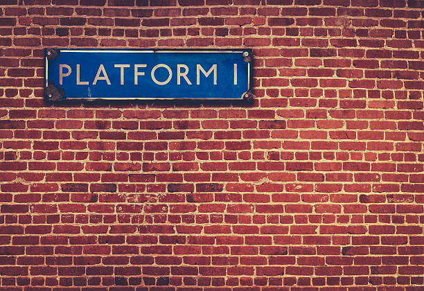 Rustic Station Platform Sign Retro British Railway Platform Sign Against A Red Brick Wall railroad station platform stock pictures, royalty-free photos & images