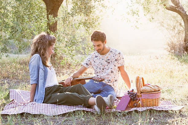 istock Loving couple picnicking among the olive trees 506343404
