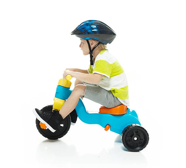 istock Little child riding tricycle 506343420