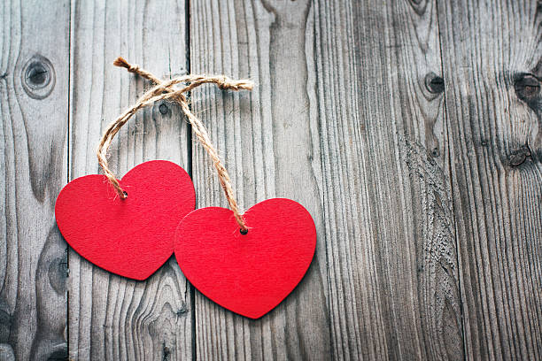 istock Two red hearts on a wooden surface. 506345316