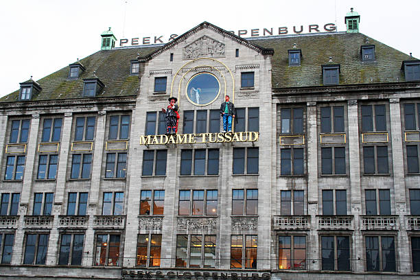 Amsterdam, Netherlands - March 26, 2009: The Madame Tussauds wax museum on Dam Square, located in the Peek & Clopenburg building. The museum is a popular tourist attraction in Amsterdam, housing the likenesses of famous people from around the world.