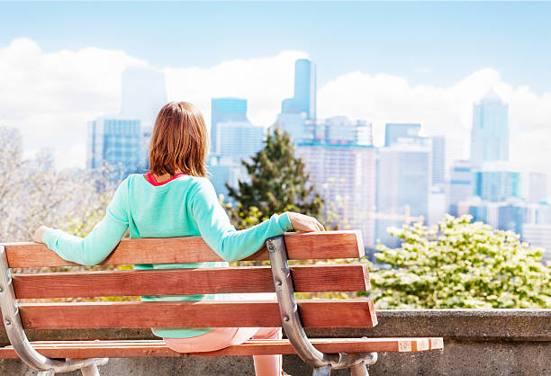 istock Young woman in Seattle park look at downtown 506345974