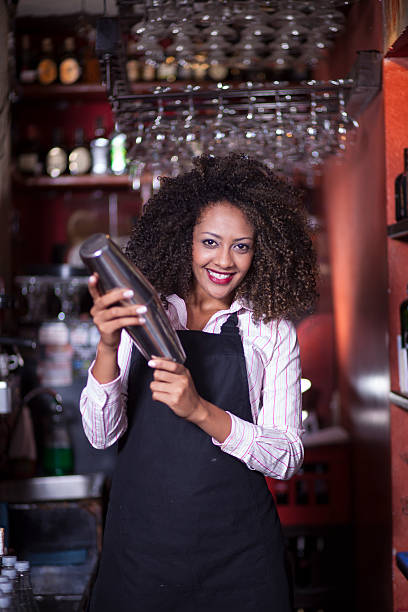 istock Pretty barmaid shaking up cocktail 506347998