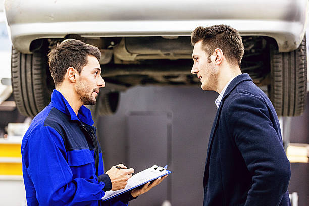 istock Auto Mechanic Talking With Car Owner 506348084