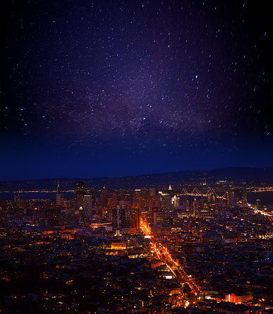 View of San Francisco downtown district during the night with stars in the sky