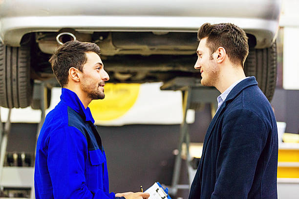 istock Auto Mechanic Talking With Car Owner 506349020