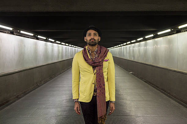 Portrait of an Indian young handsome man posing in an urban context