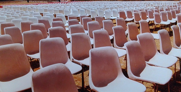 Rows of pink and white chairs.