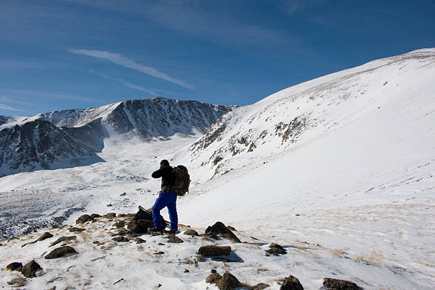 Twin Lakes, Colorado, USA - January 22, 2016: Mountain climber standing in the snow on Mount Elbert Colorado in the wintertime near Highway 82 and the town of Twin Lakes.
