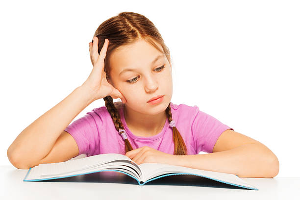 istock Schoolgirl is reading interesting book 506350076