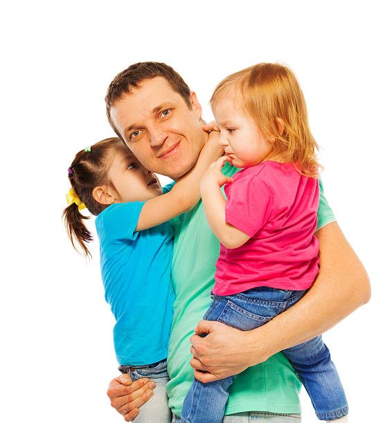 istock Father holds two daughters in his arms 506350838