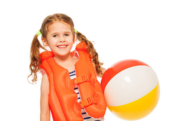 istock Smiling girl in lifejacket with colored wind-ball 506351332