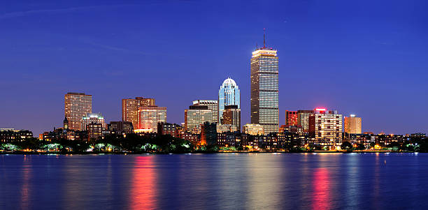 Boston city skyline at dusk Boston city skyline at dusk with Prudential Tower and urban skyscrapers over Charles River with lights and reflections. prudential tower stock pictures, royalty-free photos & images