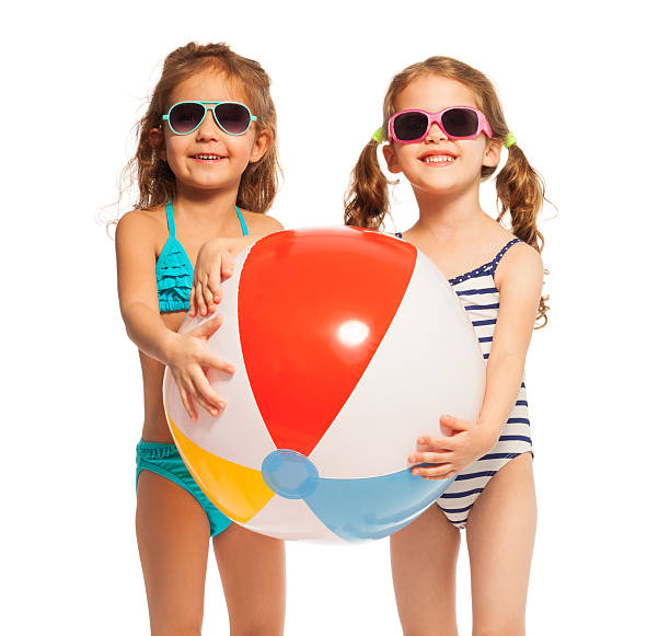 istock Two friends in sunglasses holding big wind-ball 506352398