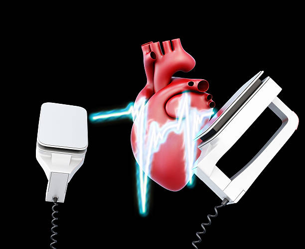 Defibrillator and heart on a black background. 3d illustration.
