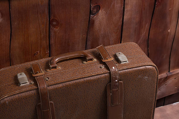 istock Retro suitcase near the fence. 506354866