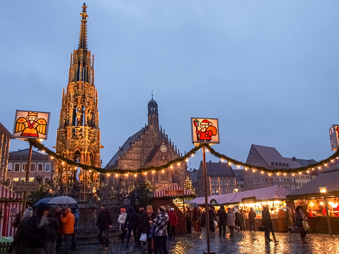 Nurenberg, Germany - December 10, 2014: Christmas market in the evening. A multitude of wooden houses decorated selling Christmas products. The evening in the city center there is the traditional market with Christmas decorations and illuminations typical.