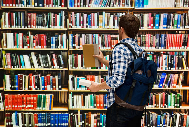 istock Student holding books in the library 506355240