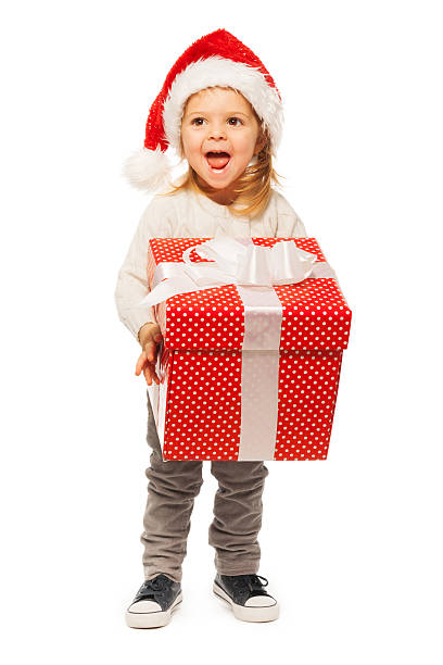 istock Little girl with big gift box and Santa hat 506355478